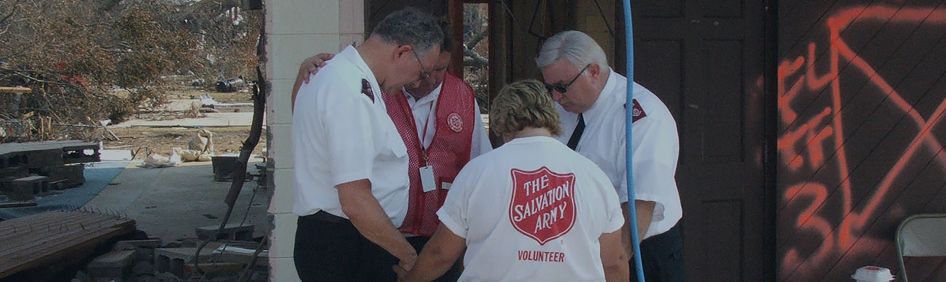 Four Salvation Army workers praying together